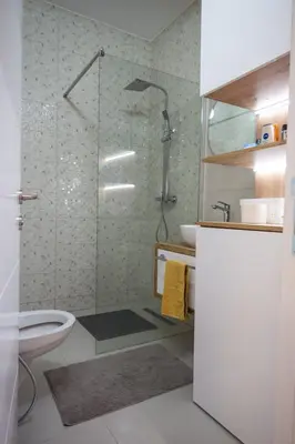 a bathroom with a shower with a toilet and a sink at 365stay in Vranje