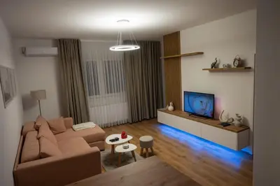 a living room with a couch and a tv at 365stay in Vranje