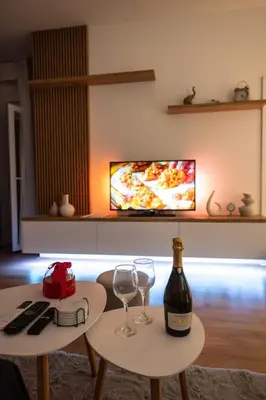 two tables with glasses and a bottle of wine at 365stay in Vranje