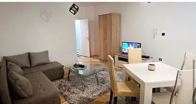 a living room with a couch and a table at Apartment Eleven in Niš