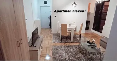 a living room with a table and a dining room at Apartment Eleven in Niš