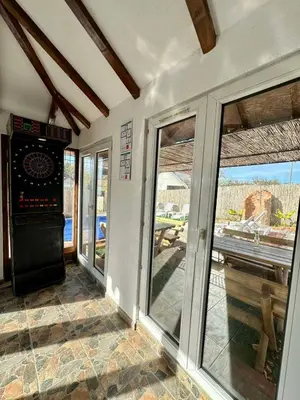 a room with a clock on the wall and windows at Brick House