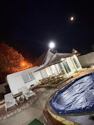 a house with a swimming pool at night at Brick House