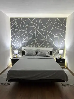 a bedroom with a large bed and two lamps at Brick House