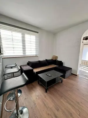 a living room with a couch and a table at Brick House