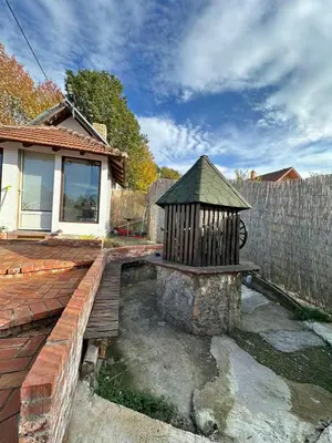 a backyard with a bird bath and a fence at Brick House