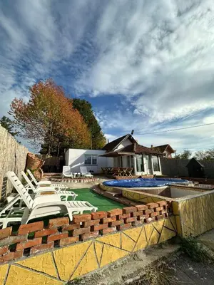 a group of lounge chairs and a swimming pool at Brick House