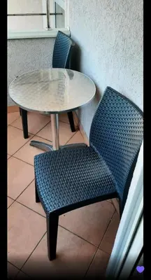 two chairs and a table and a table and chairs at Lux Studio River View in Niš