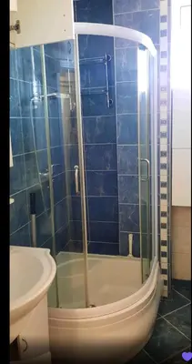 a bathroom with a shower with a toilet and a sink at Lux Studio River View in Niš