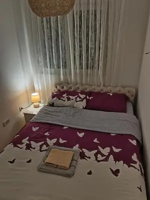 a bedroom with a bed with birds on it at Markovic san in Vrnjačka Banja