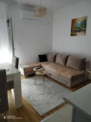 a living room with a couch and a table at Markovic san in Vrnjačka Banja