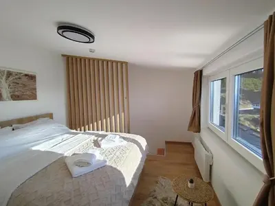 a bedroom with a large bed and a window at AlibiKopaonikSky32 in Kopaonik