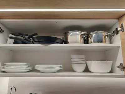 a kitchen shelf with dishes and pots and pans at AlibiKopaonikSky32 in Kopaonik