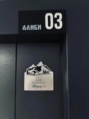 a sign on a wall with a mountain on it at Apartman Nina in Kopaonik