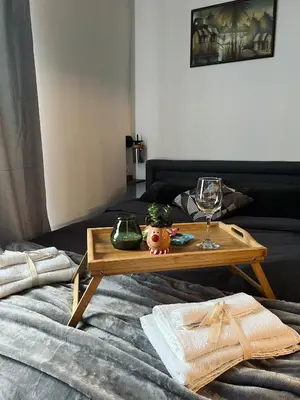a wooden coffee table sitting on top of a bed at Apartman Nina in Kopaonik
