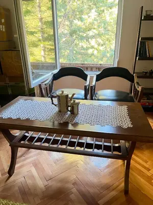 a wooden table with two chairs and a coffee table sidx sidx sidx at Viva Sićevo