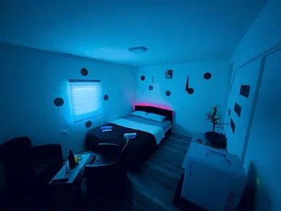 a blue room with a bed and a couch at Avram019 in Zaječar