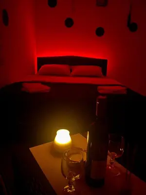 a bedroom with a bed and a candle on a table at Avram019 in Zaječar