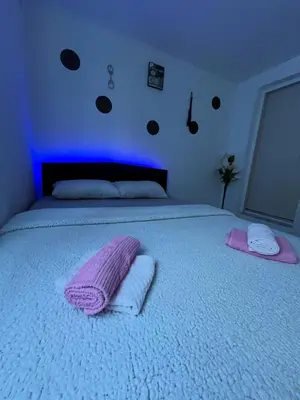 a bedroom with a bed with two towels on it at Avram019 in Zaječar