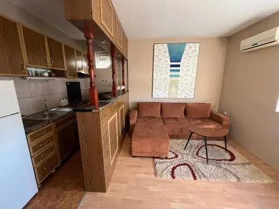 a living room with a couch and a kitchen at River apartman Paraćin in Paraćin