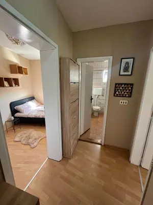 a room with a door leading to a bedroom at River apartman Paraćin in Paraćin