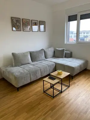 a living room with a couch and a coffee table at Apartman Adamović in Vrnjačka Banja