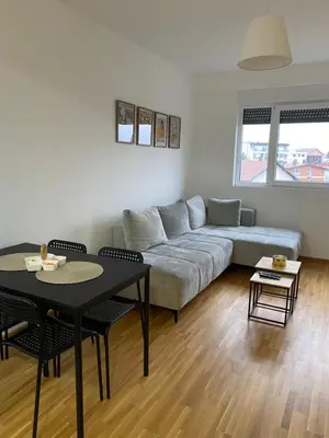 a living room with a couch and a table at Apartman Adamović in Vrnjačka Banja