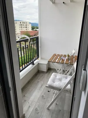 a balcony with a table and a chair on a balcony at Apartman Adamović in Vrnjačka Banja