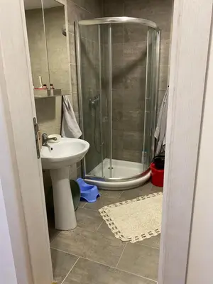 a bathroom with a shower and a sink and a toilet at Apartman Adamović in Vrnjačka Banja