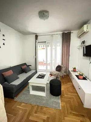 a living room with a couch and a table at Spice Apartment in Bukorovac