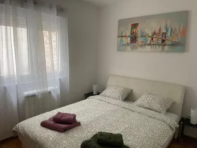 a bedroom with a bed with two towels on it at Spice Apartment in Bukorovac