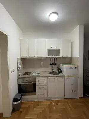 a kitchen with white cabinets and a sink at Spice Apartment in Bukorovac
