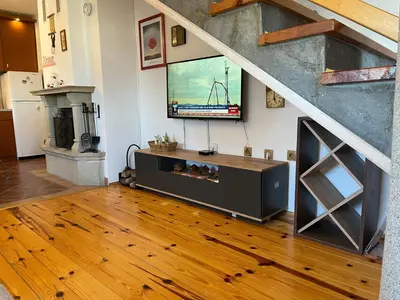 a living room with a flat screen tv on a wall at Apartments Casa Pavlovic in Kopaonik