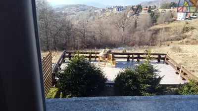a view of a wooden bridge with a water fountain at Apartments Casa Pavlovic in Kopaonik