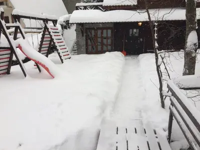 a snow covered path in front of a house at Holiday Home Minja in Kopaonik