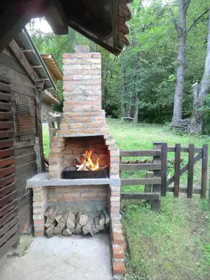 a brick oven with a fire inside of it at Holiday Home Minja in Kopaonik