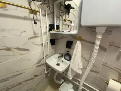 a white bathroom with a sink and a toilet at Deda Bocin konak