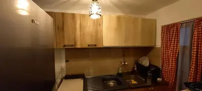 a kitchen with wooden cabinets and a sink at Deda Bocin konak