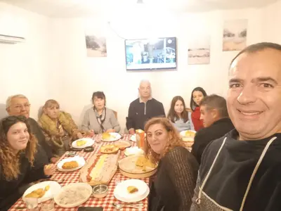 a group of people sitting at a table eating at Deda Bocin konak