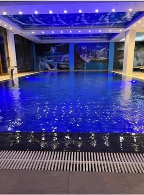 a large pool with blue water in a building at A&N President Kop in Kopaonik