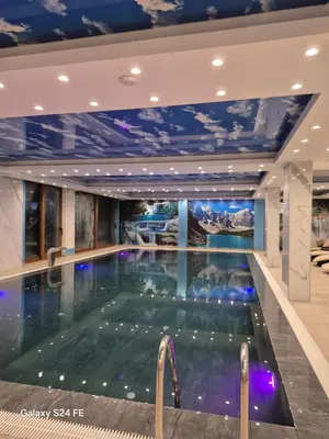 a large swimming pool in a building with a ceiling at A&N President Kop in Kopaonik