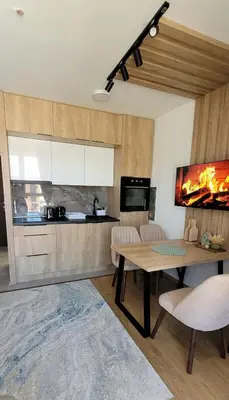 a kitchen with a table and a dining room at A&N President Kop in Kopaonik