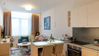a kitchen and a living room with a table and a kitchen at Zepterme Harmony in Vrnjačka Banja