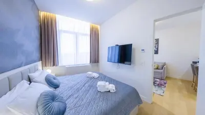 a bedroom with a bed with towels on it at Zepterme Harmony in Vrnjačka Banja