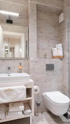 a bathroom with a sink and a toilet and a mirror at Zepterme Harmony in Vrnjačka Banja
