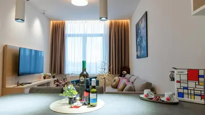 a living room with a bottle of wine on a table at Zepterme Harmony in Vrnjačka Banja