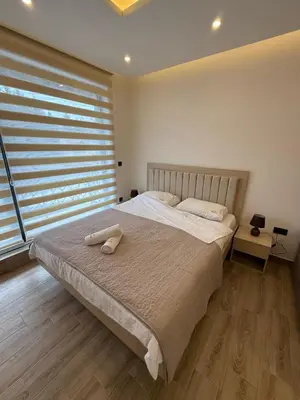 a bedroom with a large bed with a large window at Apartman SEVN in Kopaonik