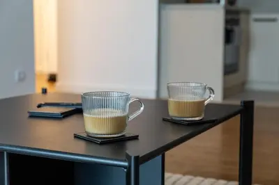 two cups of coffee sitting on a table at Planet Gemini Residence & SPA in Niš