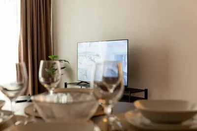 a table with two wine glasses on top of it at Planet Gemini Residence & SPA in Niš