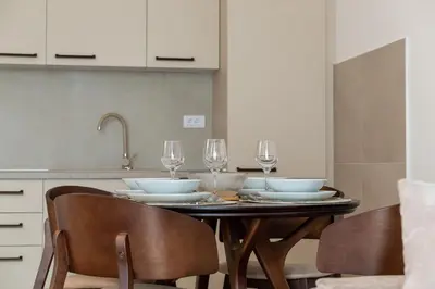 a dining room table with wine glasses on it at Planet Gemini Residence & SPA in Niš